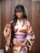 A woman in a kimono posing for a picture.