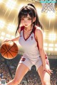 A girl in a basketball uniform holding a basketball.